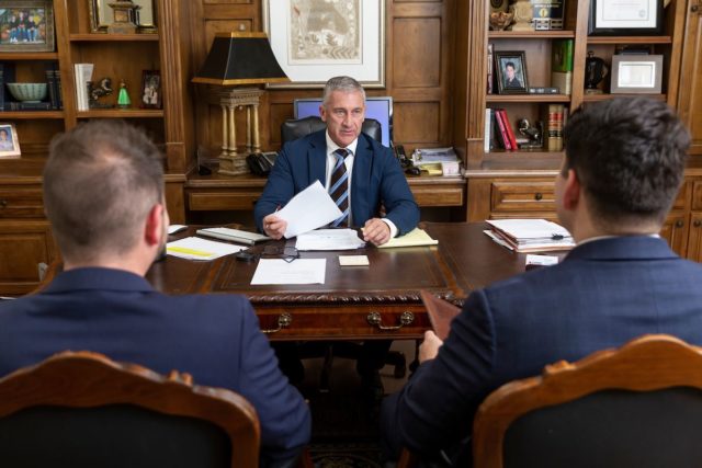 Lawyer Bill Reynolds in his office with employees