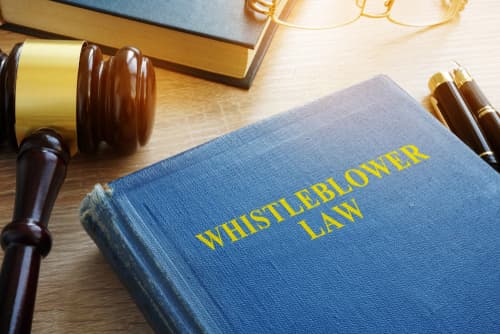 whistleblower law book on desk next to gavel