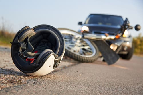 motorcycle and helmet on road after accident with a vehicle