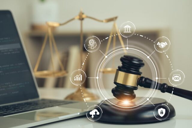 Judicial gavel and laptop with legal icons, representing AI ethics, AI law, and technology regulations.