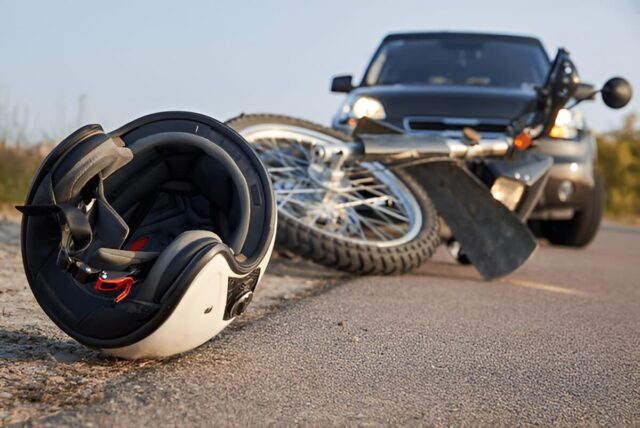 Photo of car, helmet and motorcycle on road, the concept of road accidents.