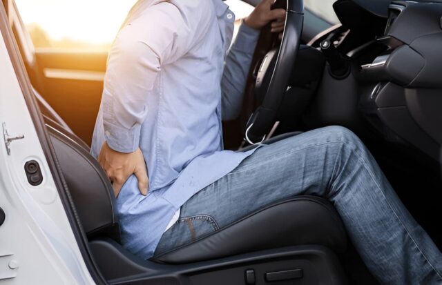 Close-up shot of a man with severe back pain after sideswipe accident.