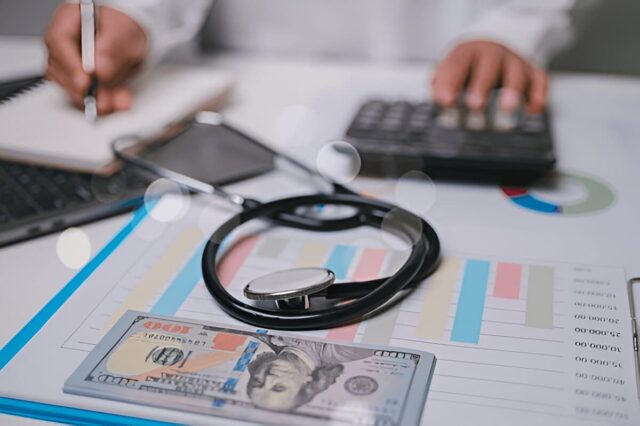 Stethoscope and money symbolize the link between healthcare and financial management.