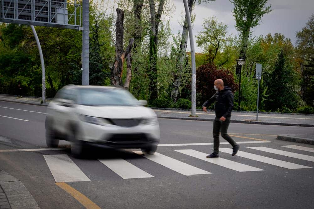 Pedestrian walking on zebra crossing and a driving car failing to stop in blurred motion. Pedestrian reacts with hand to the driver.|Driving under alcohol influence. Drunk driver with beer bottle in car.|The conceptual phrase EVIDENCE made up of blocks with the help of a hand on a red background
